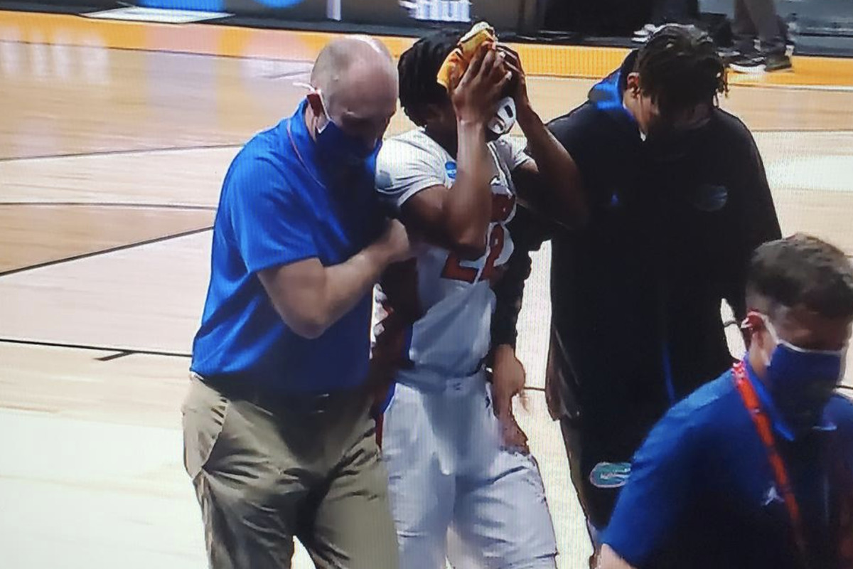 Tyree Appleby walks off with a towel over his face after getting hit with an inadvertent elbow.