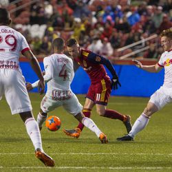 Real Salt Lake midfielder Albert RusnÁk (11) and New York Red Bulls midfielder Tyler Adams (4) and defender Tim Parker (26) go for the ball during Real Salt Lake's 1-0 win against the New York Red Bulls at Rio Tinto Stadium in Sandy on Saturday, March 17, 2018.