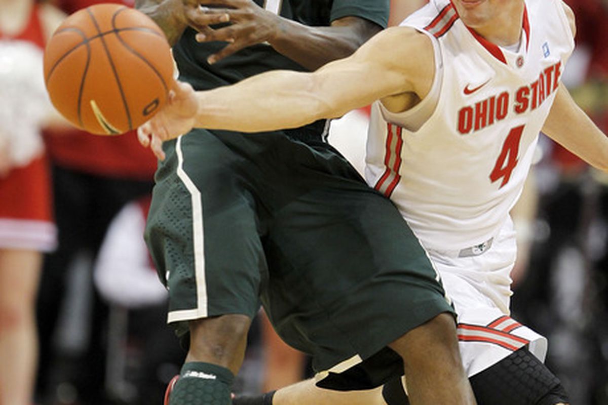 COLUMBUS OH - FEBRUARY 15:  Aaron Craft #4 of the Ohio State Buckeyes knocks the ball away from Kalin Lucas #1 of the Michigan State Spartans (Photo by Gregory Shamus/Getty Images)