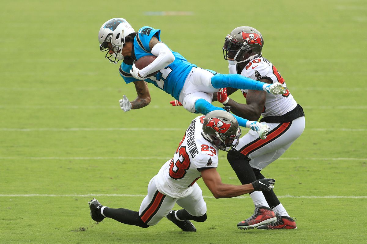 Robby Anderson #11 of the Carolina Panthers is upended as he is tackled by Sean Murphy-Bunting #23 and Jason Pierre-Paul #90 of the Tampa Bay Buccaneers during the third quarter at Raymond James Stadium on September 20, 2020 in Tampa, Florida.