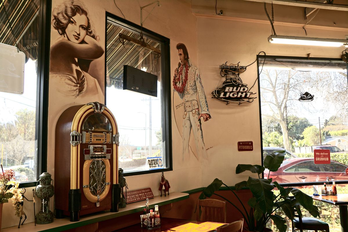 A jukebox and various celebrity murals inside Ranch Side Cafe.