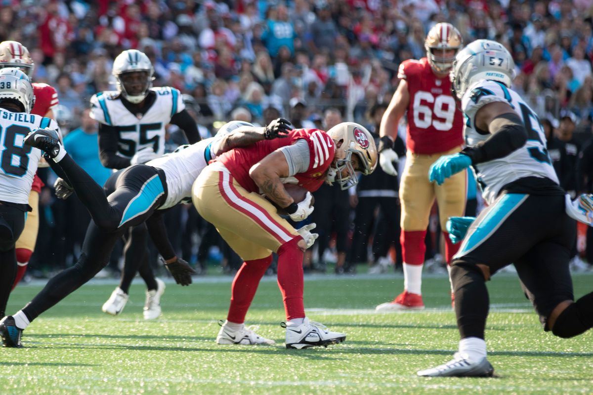 George Kittle #85 of the San Francisco 49ers runs after making a catch during the game against the Carolina Panthers at Bank of America Stadium on October 9, 2022 in Charlotte, North Carolina.