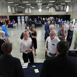 Lori Haglund and Neil Spencer ask questions at the design and operations table during a public open house in Salt Lake City, Wednesday, May 20, 2015, for citizens to learn about the five potential sites for the new Utah State Correctional Facility.