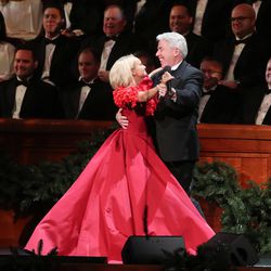 Kristin Chenoweth dances with a choir member while singing with the Tabernacle Choir at Temple Square during their opening Christmas concert in Salt Lake City on Thursday, Dec. 13, 2018.