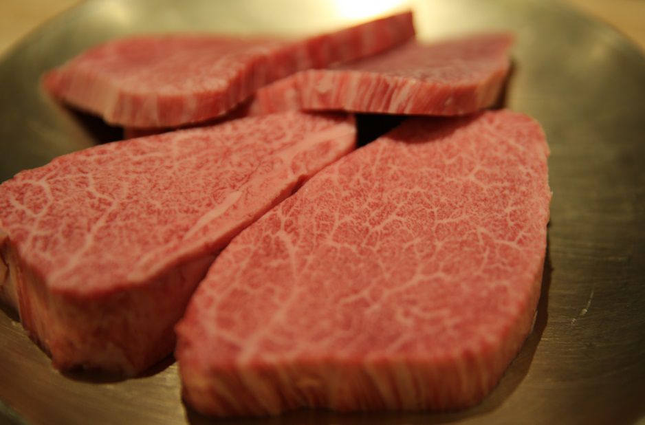 Several thin and excessively marbled steaks.