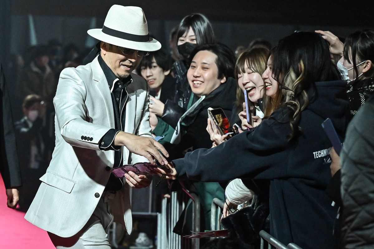 Takaya Kuroda meeting with fans as he arrives for a red carpet presentation and press conference in Yokohama, ahead of the launch of “Like a Dragon: Infinite Wealth”, the latest in the Japanese video game “Yakuza” franchise on January 26. Behind the worldwide success of Japanese video games lies a delicate task: appealing to overseas players whose expectations on issues like sexism are increasingly influencing the content of major titles. (Photo by Richard A. Brooks / AFP)