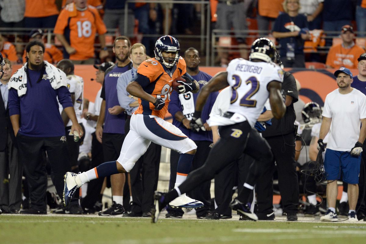Denver Broncos tight end Julius Thomas is chased by Baltimore Ravens safety James Ihedigbo