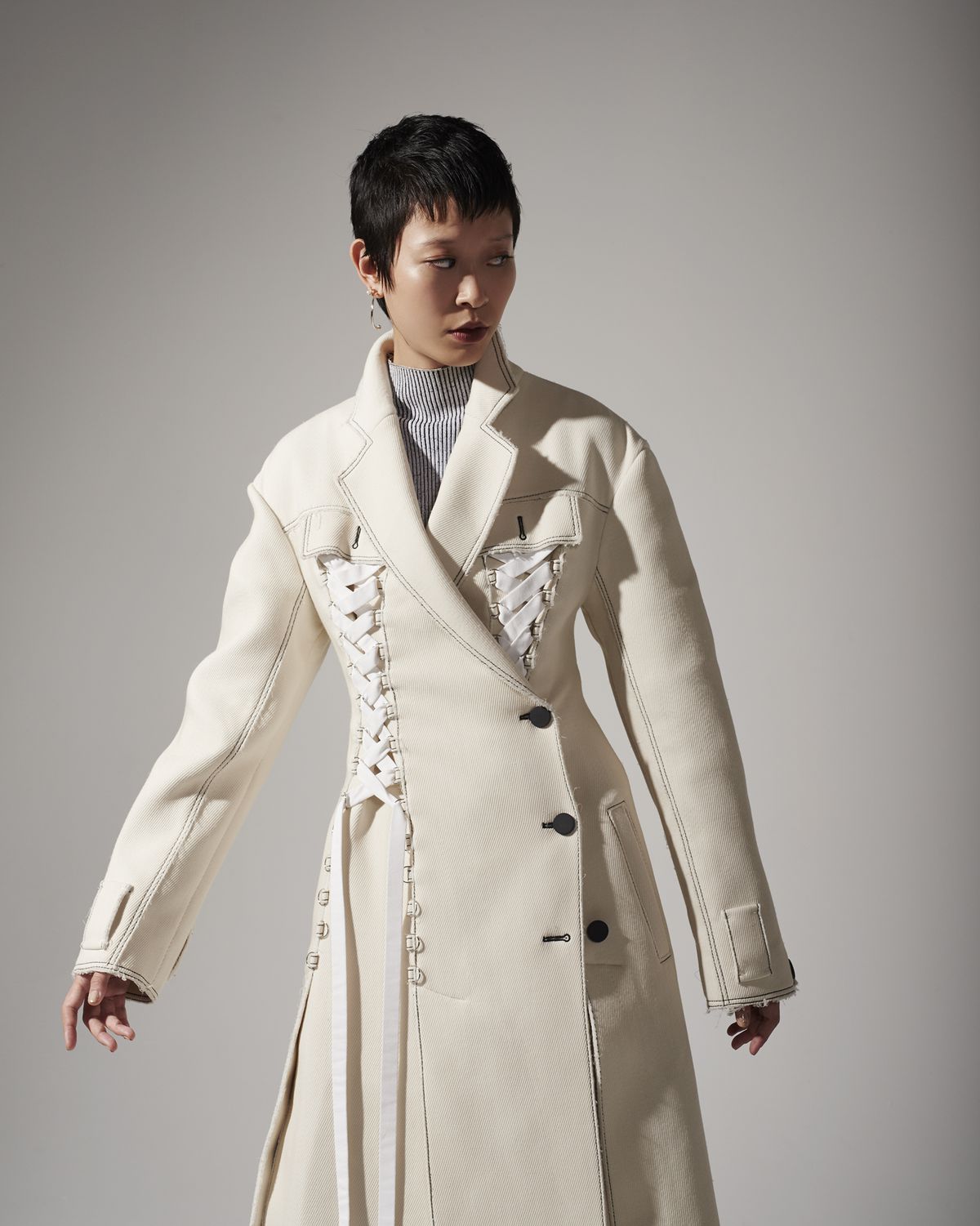 A model wearing a long white coat