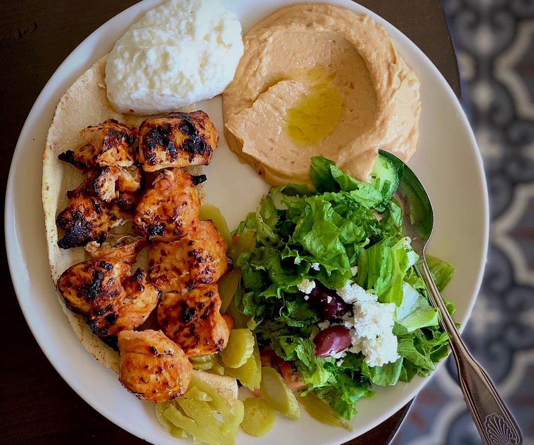 A plate of assorted dishes, including salad and hummus, from the L.A. restaurant Open Sesame. 