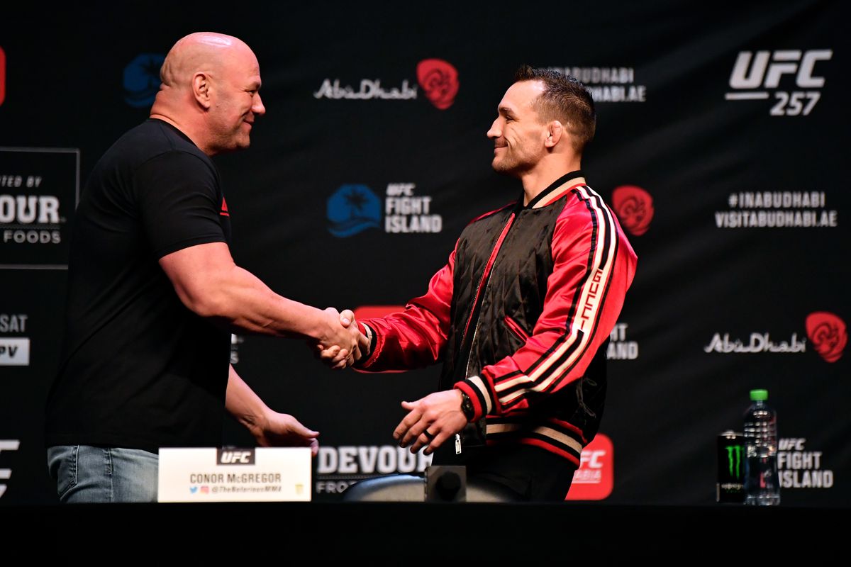 Michael Chandler and Dana White shake hands at a UFC 257 press event.