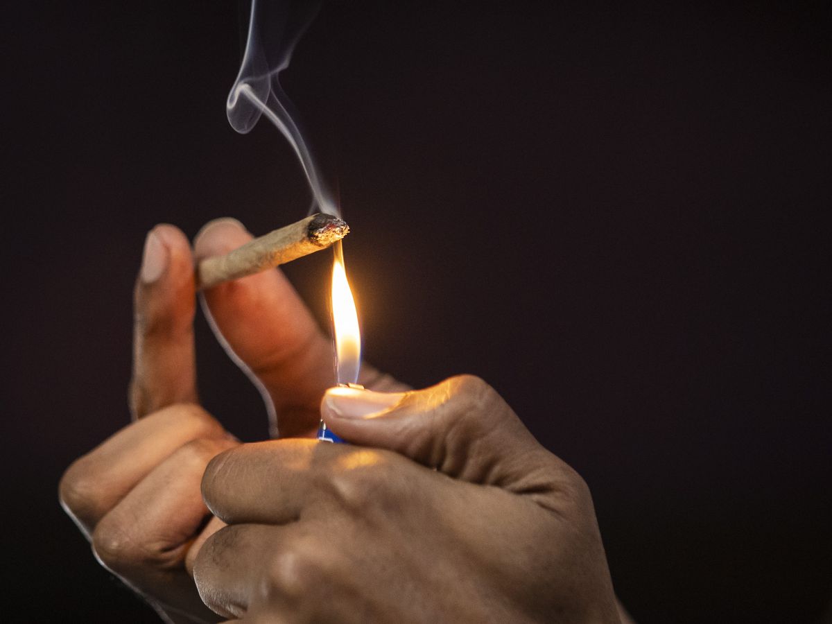 Photos of hands holding a cannabis joint and a lighter.
