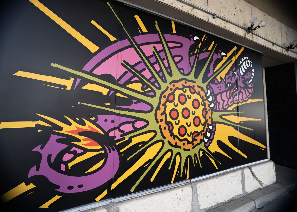 A pizza and dragon-themed mural at Betelgeuse Betelgeuse.