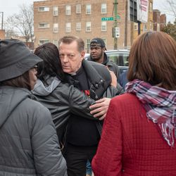 St. Sabina Pastor Michael Pfleger hugs a woman at the scene where Dareyona Smith was killed a day earlier. | Nader Issa/Sun-Times