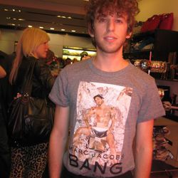 A Marc Jacobs' employee models their free T-shirt, which features A LOT of Marc Jacobs on it.