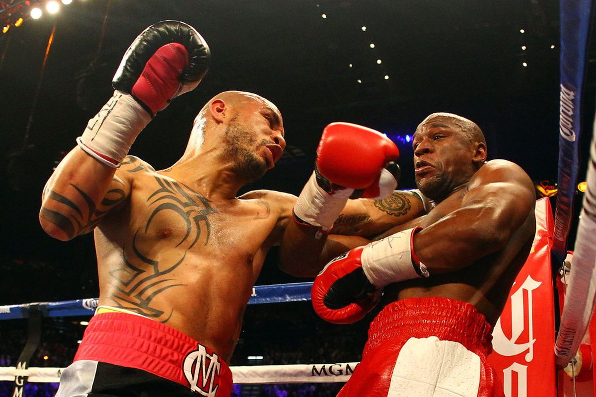 LAS VEGAS, NV - MAY 05:  (L-R) Miguel Cotto and Floyd Mayweather Jr. exchange blows during their WBA super welterweight title fight at the MGM Grand Garden Arena on May 5, 2012 in Las Vegas, Nevada.  (Photo by Al Bello/Getty Images)