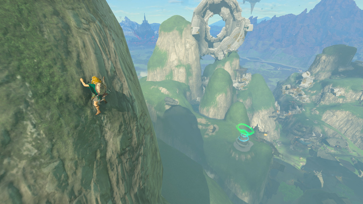 Link climbs a sheer cliff in The Legend of Zelda: Tears of the Kingdom. In the background, a shrine can be seen amid strange rock formations