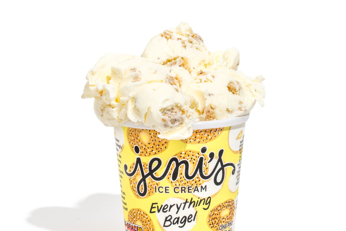 A yellow pint overflowing with Everything Bagel flavored ice cream from Jeni’s Splendid Ice Creams