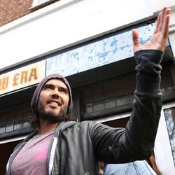 FILE - In this Thursday, March 26, 2015 file photo, Russell Brand speaks at the opening of The Trew Era Cafe, a social enterprise community project on the New Era estate in east London. Comedian turned political activist Russell Brand has changed his mind and is no longer urging people not to vote in Thursday's general election. Instead, Brand on Monday, May 4, 2015 used his YouTube channel to urge his more than 1 million subscribers to back the Labour Party's Ed Miliband. (Photo by Joel Ryan/Invision/AP, File)
