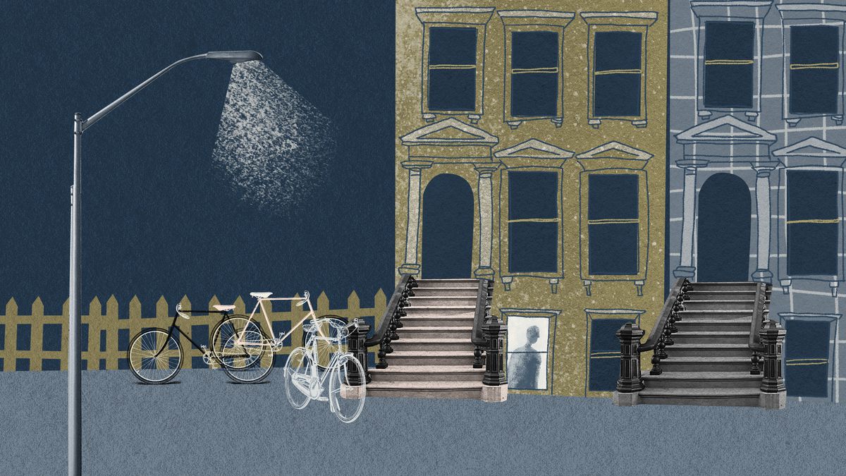 An illustration of an apartment building at night, with a streetlamp hanging over a sidewalk filled with bikes.