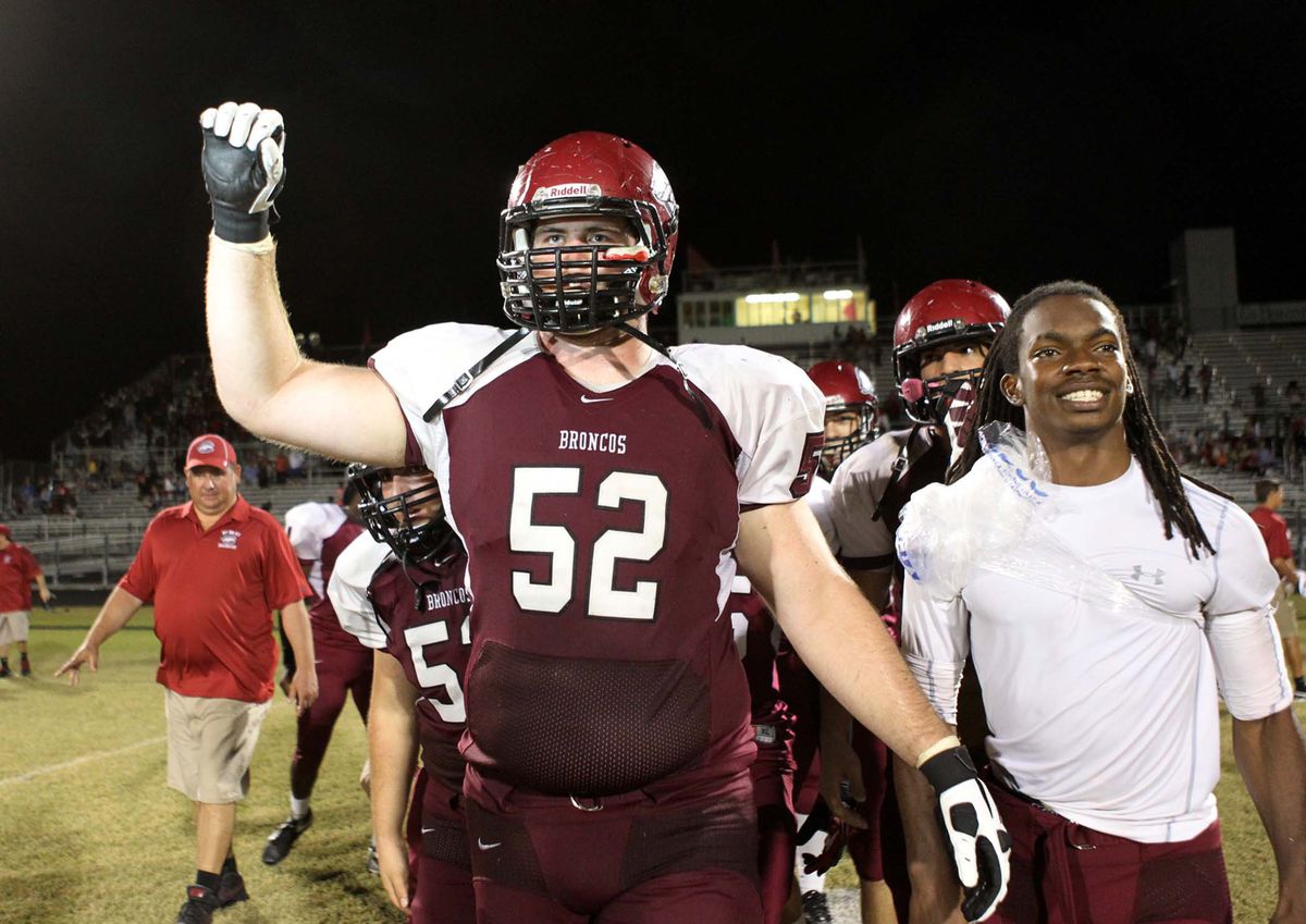 KC McDermott (52), of Palm Beach Central, and quarterback Kemar Downer (4), right, after defeating Park Vista at Palm Beach Central in Wellington, Fla., Friday, Nov. 1, 2013. (Gary Coronado/The Palm Beach Post)
