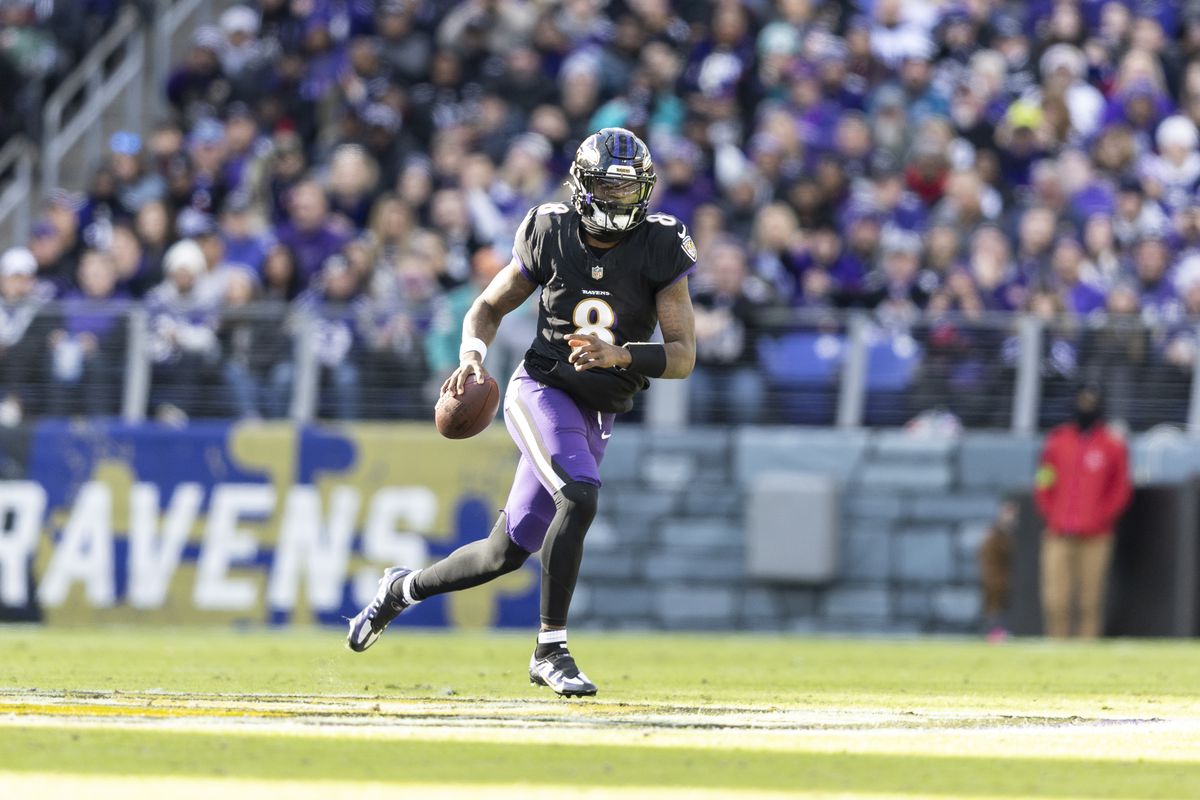 Lamar Jackson of the Baltimore Ravens scrambles and looks to pass during an NFL football game between the Baltimore Ravens and the Miami Dolphins at M&amp;T Bank Stadium on December 31, 2023 in Baltimore, Maryland.