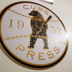 Replica of old World Series press pin, on stairs up to press box