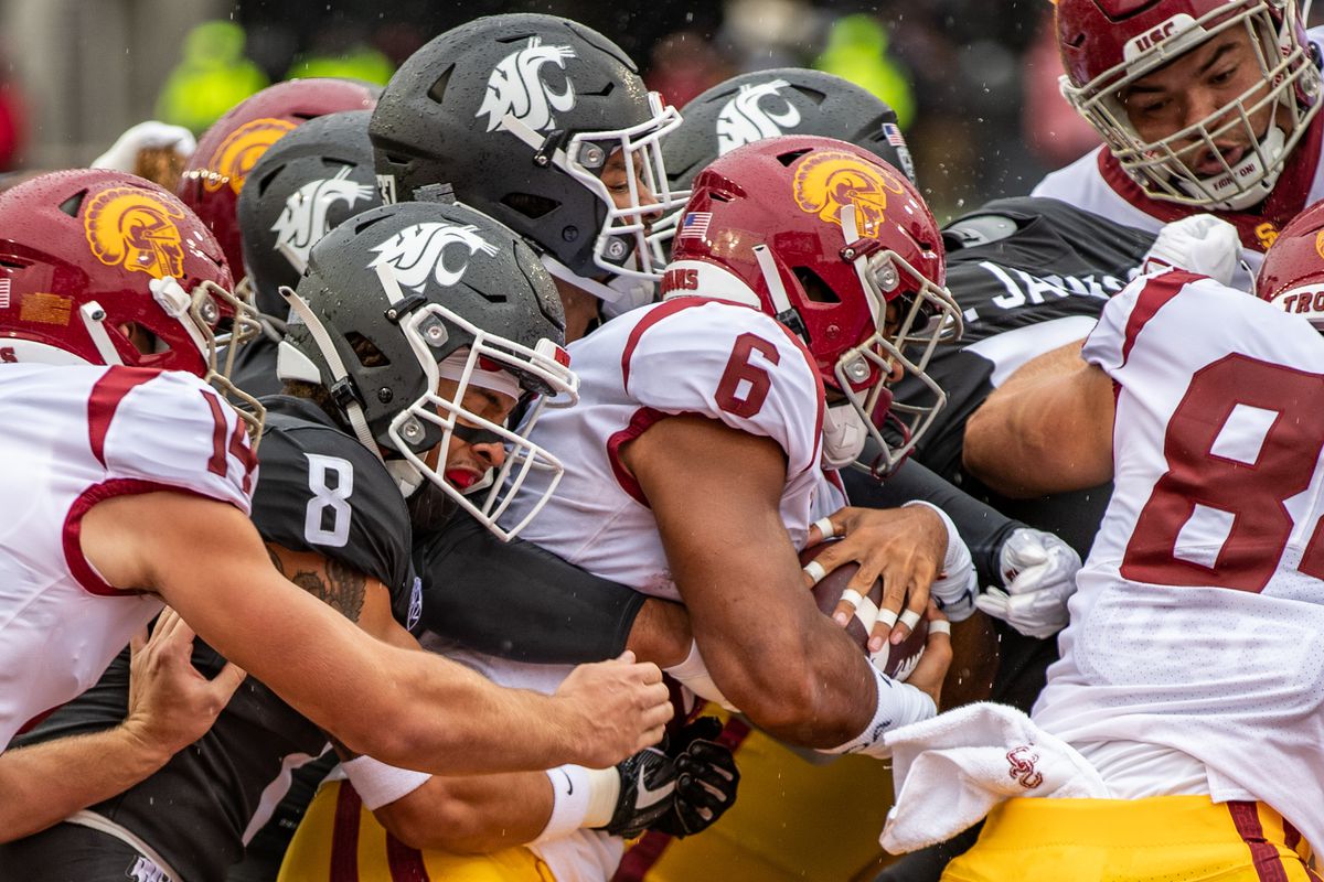 PULLMAN, WA - SEPTEMBER 18: Washington State defense wrap up a USC running back during the first half of a PAC 12 conference matchup between the USC Trojans and the Washington State Cougars on September 18, 2021, at Martin Stadium in Pullman, WA.