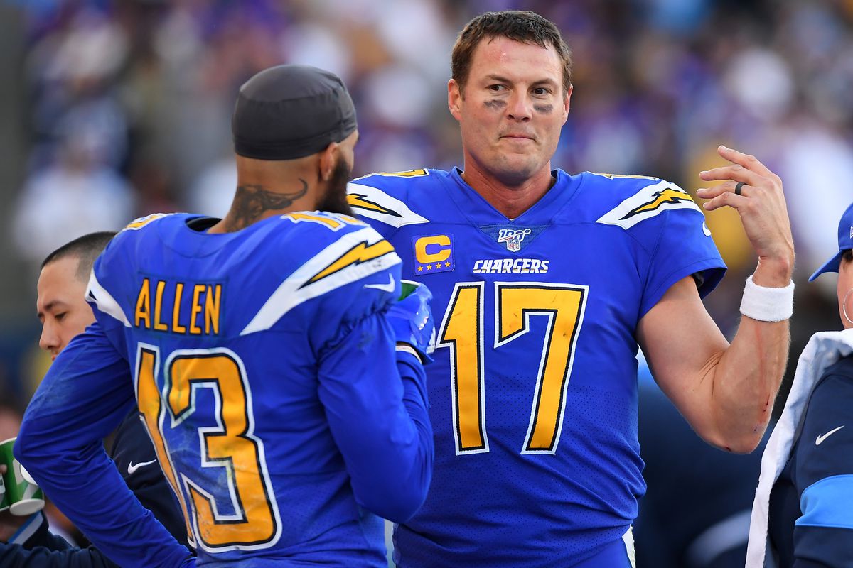 Quarterback Philip Rivers #17 talks with wide receiver Keenan Allen #13 of the Los Angeles Chargers on the bench in the second half of the game against the Minnesota Vikings at Dignity Health Sports Park on December 15, 2019 in Carson, California.