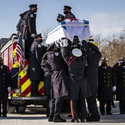 Chicago Fire Department firefighter MaShawn Plummer’s casket is loaded onto a fire truck in preparation for the procession to the cemetery after his funeral at the House of Hope church on the Far South Side, Thursday, Jan. 6, 2022. 