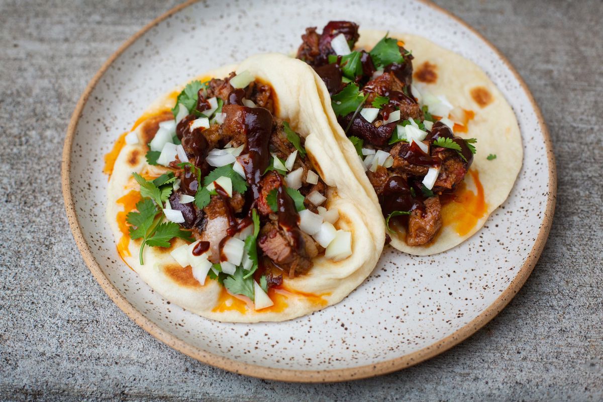 Two tacos filled with shaved meat from the Portland-based pop-up Astral.