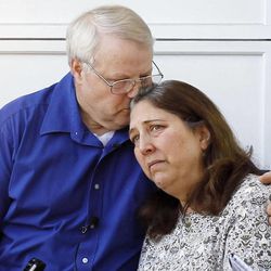 Chuck and Judy Cox hug at their home in Puyallup, Wash., Monday, Feb. 6, 2012.