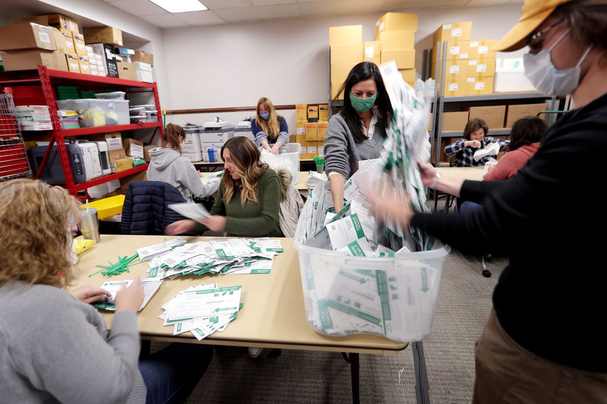 Workers go through every envelope making sure all the ballots have been taken out and counted at the Utah County Clerk/Auditor’s Office in Provo on Tuesday, Oct. 27, 2020.