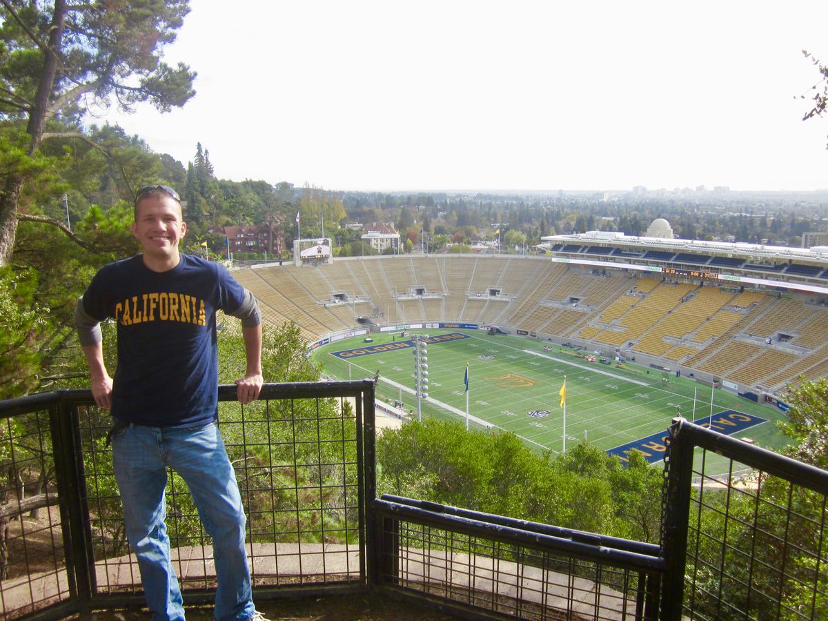 College football fan standing on scenic overlook.
