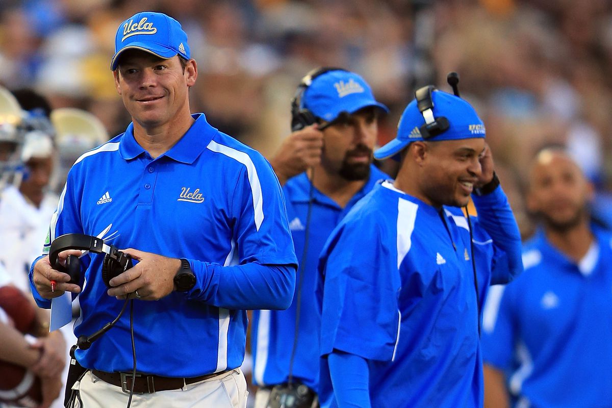 There are some pretty good recruiters next to Mora on the UCLA sidelines.