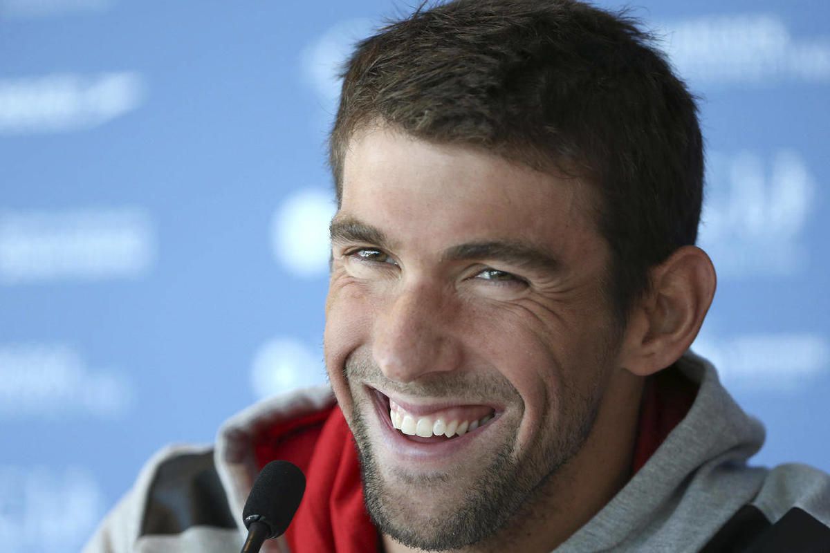 FILE - In this Aug. 20, 2014, file photo, U.S. swimmer Michael Phelps laughs during a news conference ahead of the Pan Pacific swimming championships in Gold Coast, Australia. The 18-time Olympic gold medalist on Sunday, Feb. 22, 2015 announced on Twitter