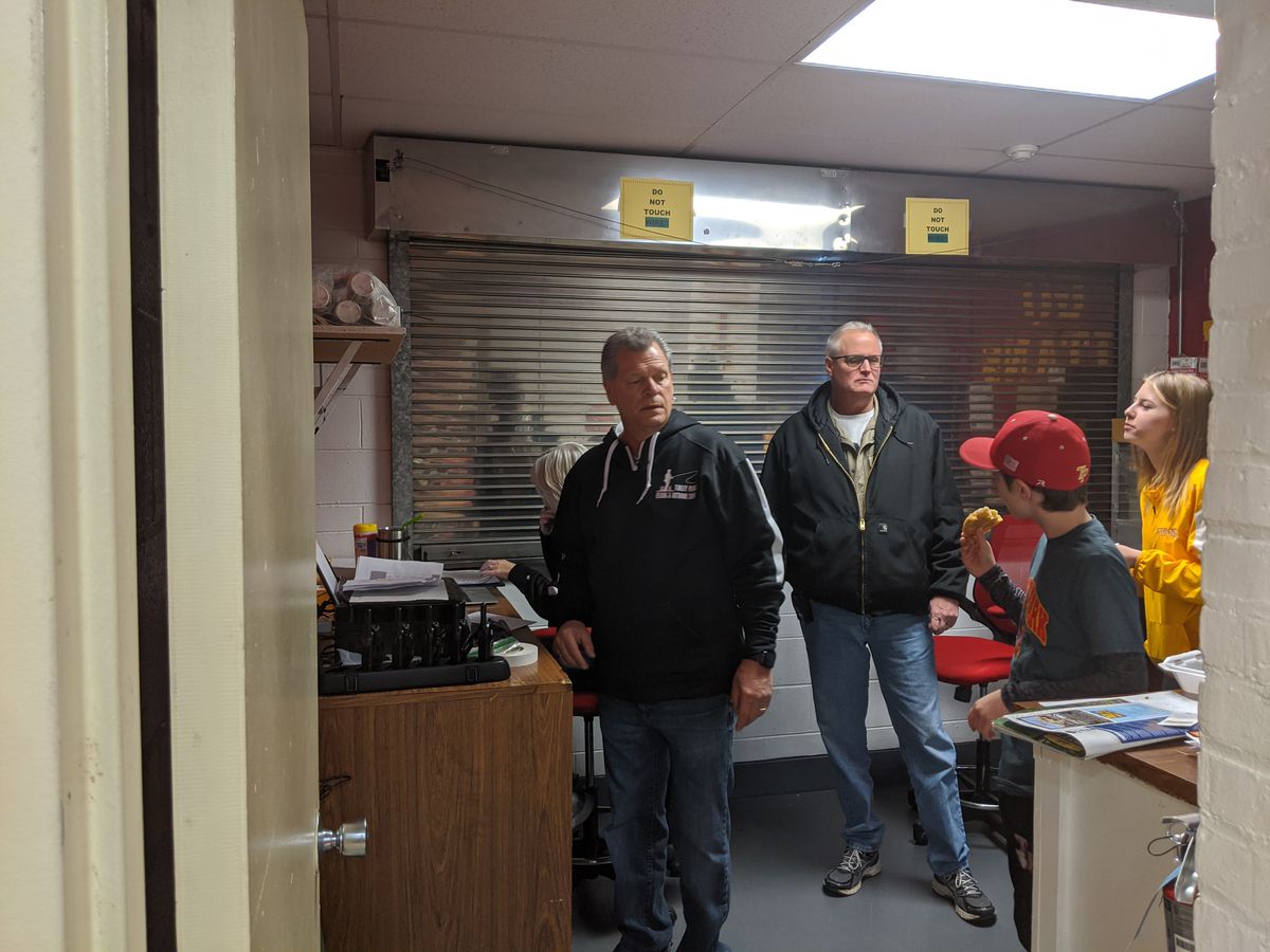 Rich Komar (left) working in the office at his last fishing show in Tinley Park, held in February 2020. Credit: Dale Bowman