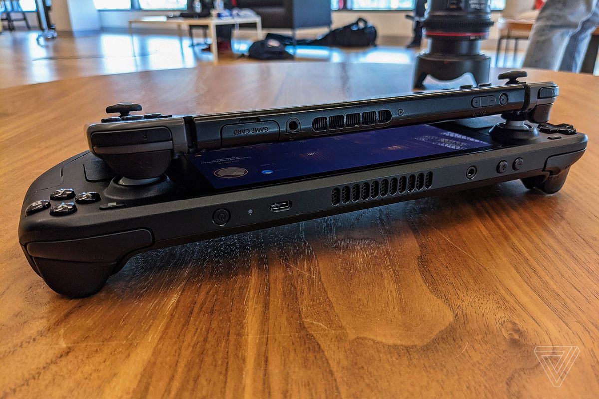 The Nintendo Switch atop a Steam Deck, showing its akin  plan  and array of ports.