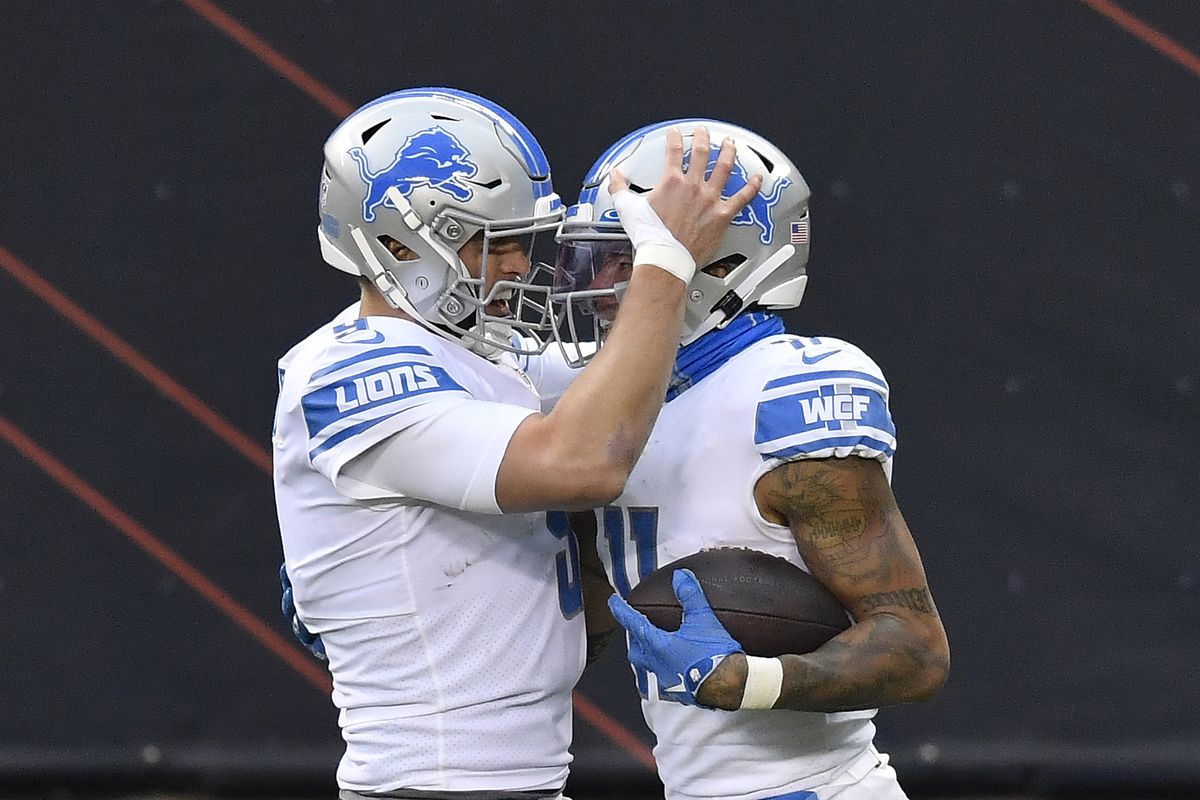 Matthew Stafford #9 and Marvin Jones Jr. #11 of the Detroit Lions celebrate their 25-yard touchdown pass against the Chicago Bears during the second half at Soldier Field on December 06, 2020 in Chicago, Illinois.