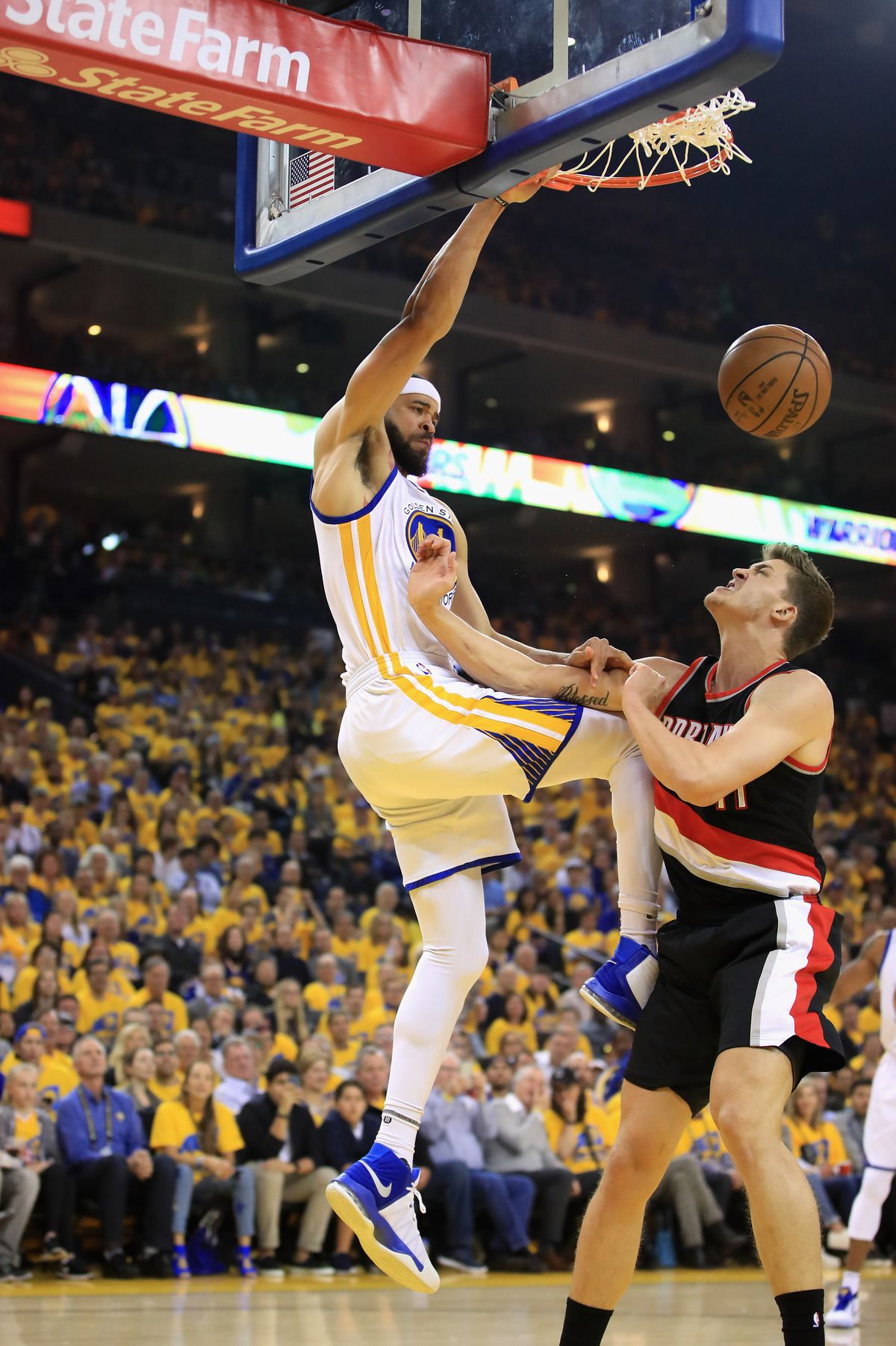 Portland Trail Blazers center Meyers Leonard gets dunked on by Golden State Warriors center JaVale McGee