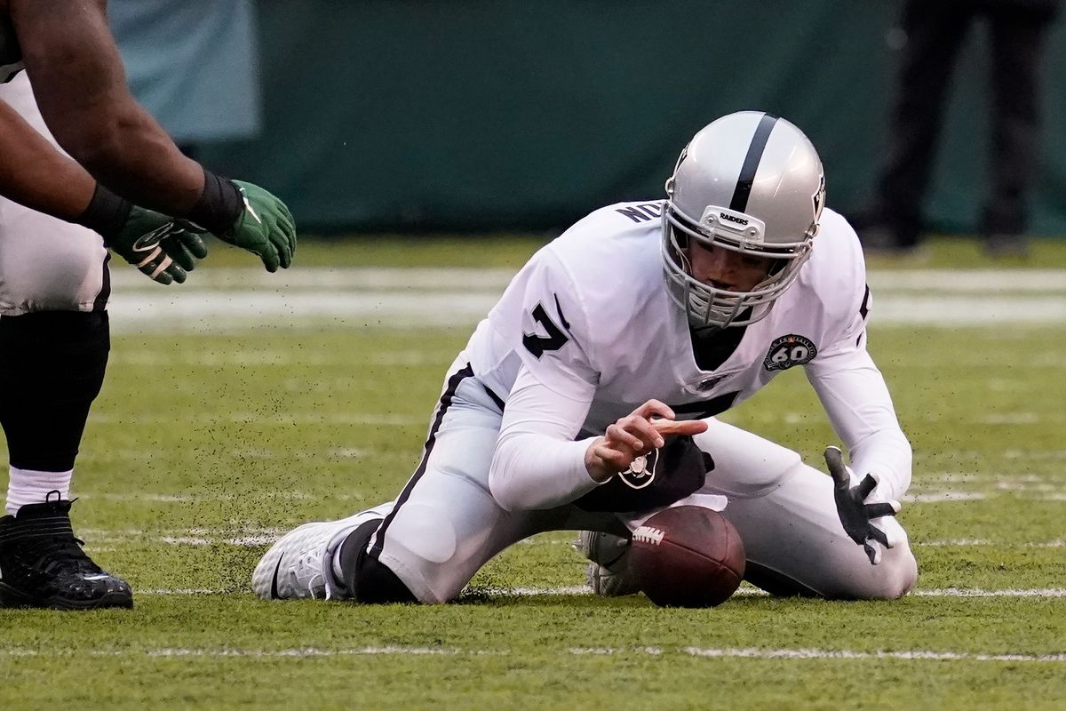 Oakland Raiders quarterback Mike Glennon recovers his own fumble during the third quarter against the New York Jets at MetLife Stadium.