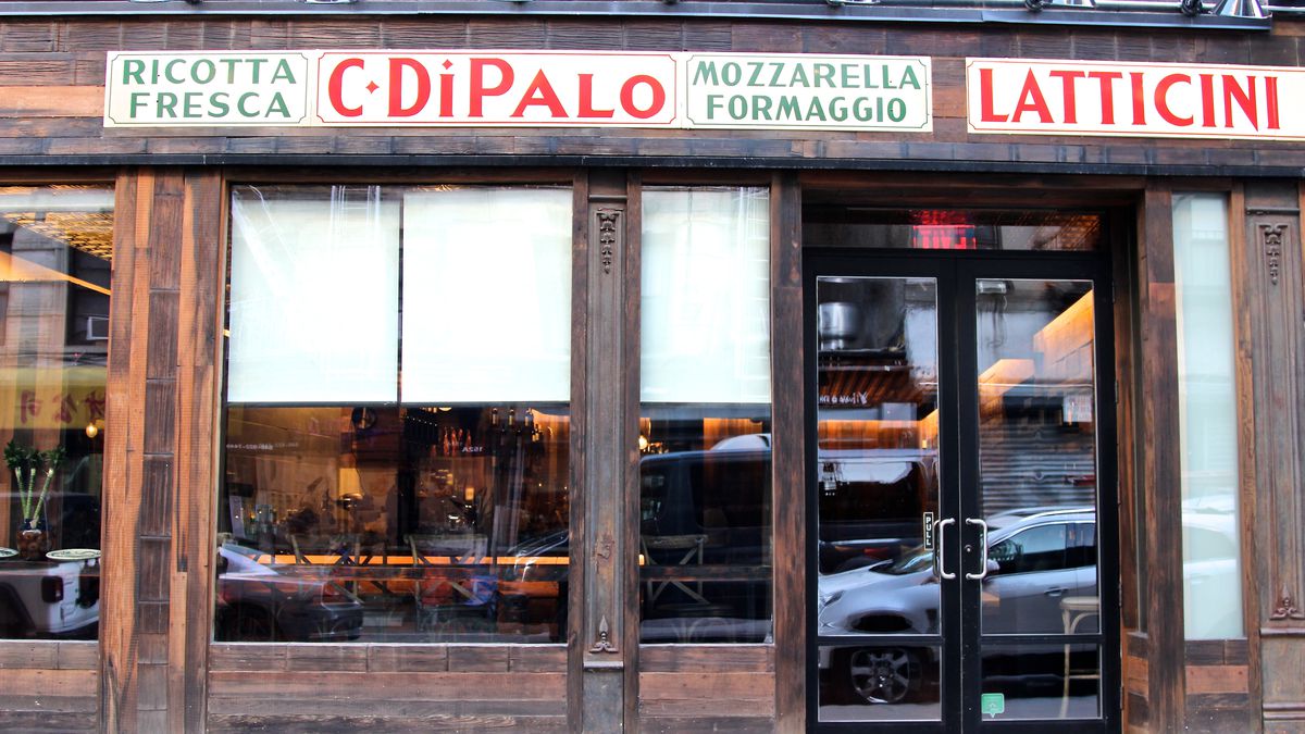 The exterior of a wine bar with the sign reading C. Di Palo in red letters