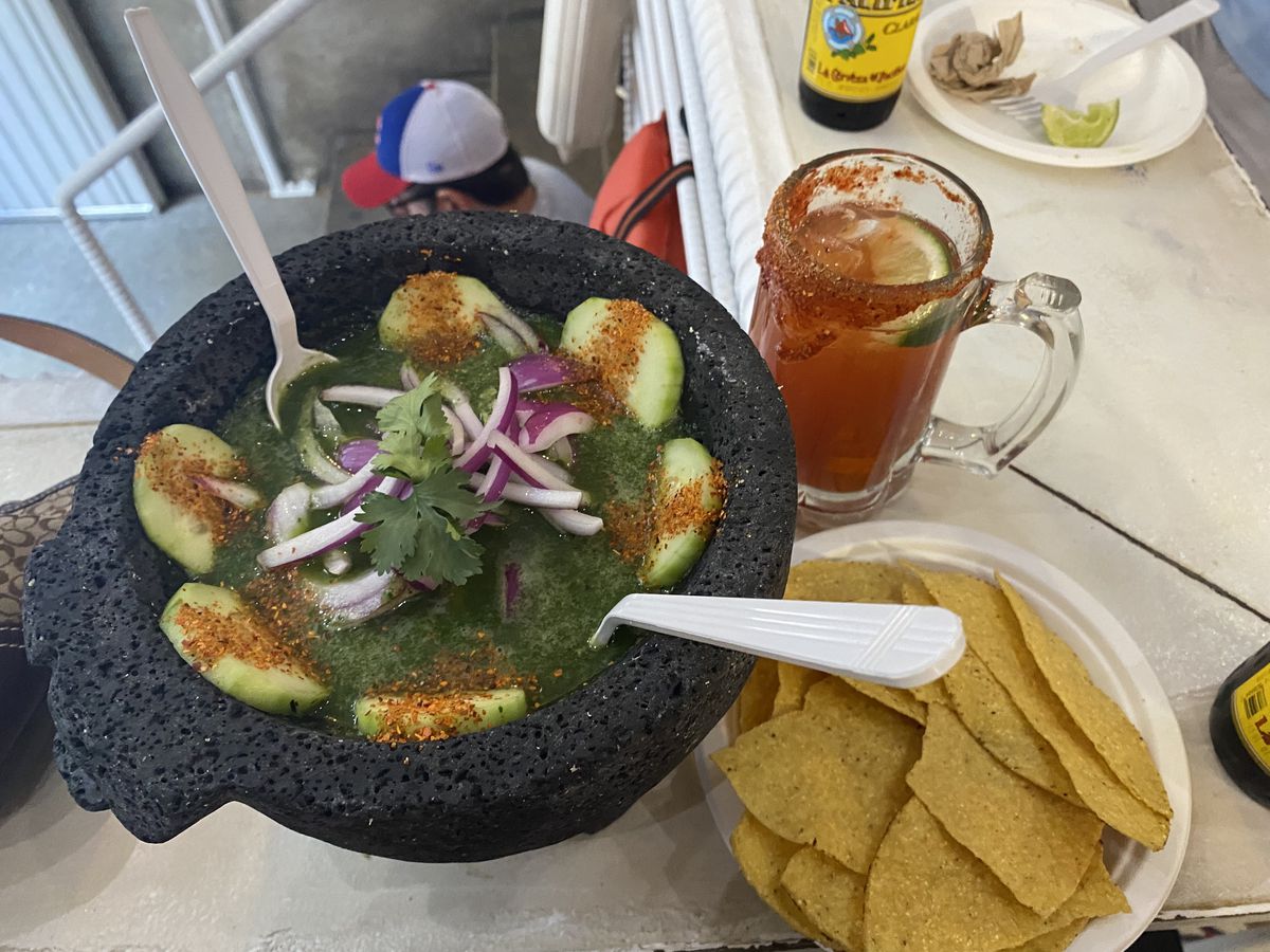Cucumbers, shrimp, and red onion overflow from a molcajete at Los Mariscos in Chelsea Market.