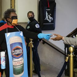 Mayor Lori Lightfoot and Dr. Allison Arwady, commissioner of the Chicago Department of Public Health, wear “Rona Destroyer” costumes and pass out candy in City Hall shortly after a press conference about Halloween in Chicago, Thursday afternoon, Oct. 1, 2020.