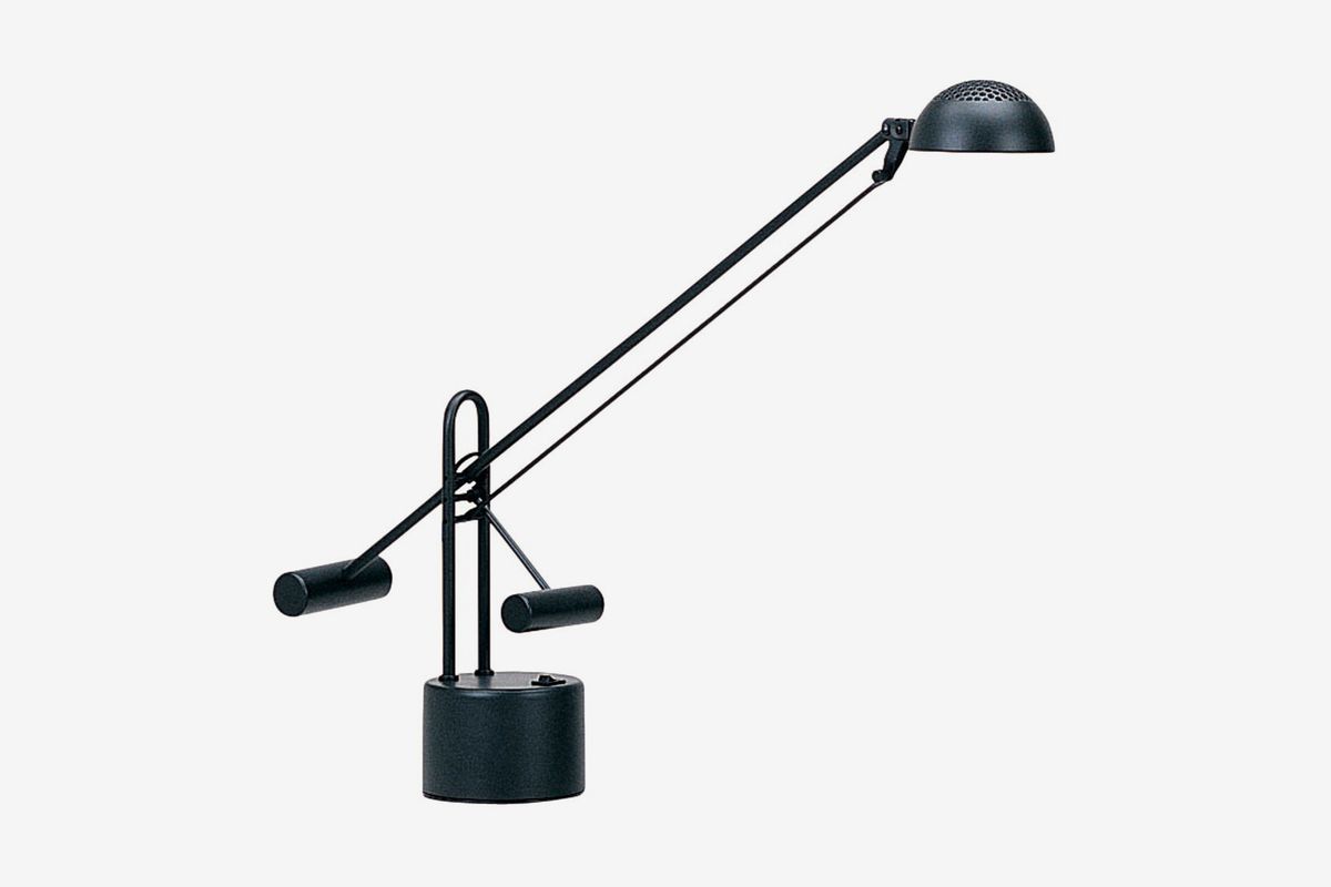 Black lamp with cylindrical base and long arm.