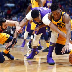 New Orleans Pelicans forward Anthony Davis, center, battles for loose ball between Utah Jazz guard Donovan Mitchell (45) and guard Ricky Rubio in the first half of an NBA basketball game in New Orleans, Monday, Feb. 5, 2018. (AP Photo/Gerald Herbert)