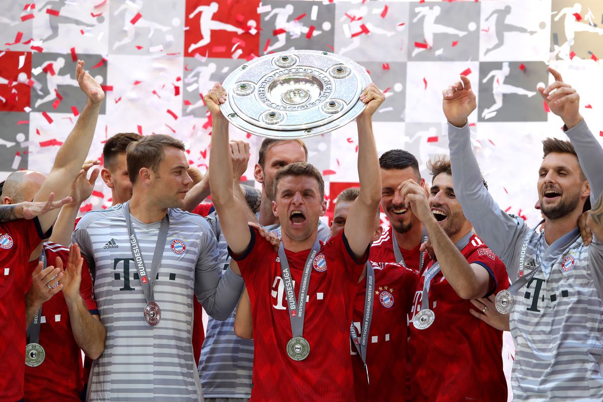 MUNICH, GERMANY - MAY 12: Thomas Mueller of Bayern Muenchen lifts the Bundesliga trophy following the Bundesliga match between FC Bayern Muenchen and VfB Stuttgart at Allianz Arena on May 12, 2018 in Munich, Germany. 