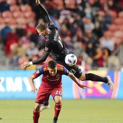 D.C. United defender Frederic Brillant (13) falls over Real Salt Lake midfielder Luis Silva (20) as Real Salt Lake and D.C. United play an MLS Soccer match at Rio Tinto Stadium in Sandy on Saturday, May 12, 2018. RSL won 3-2.
