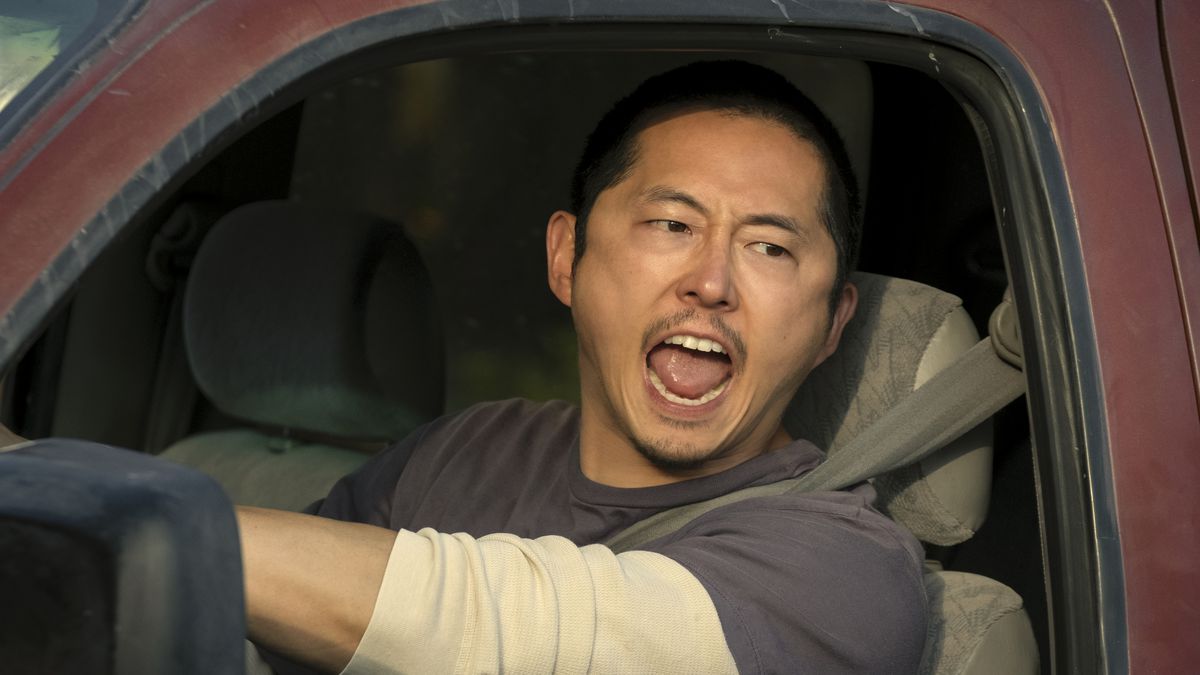 Steven Yeun yells while driving a red truck in Beef