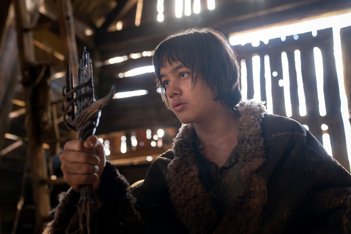 Tyroe Muhafidin (Theo), a young boy, stares at a messed-up looking sword that he’s holding