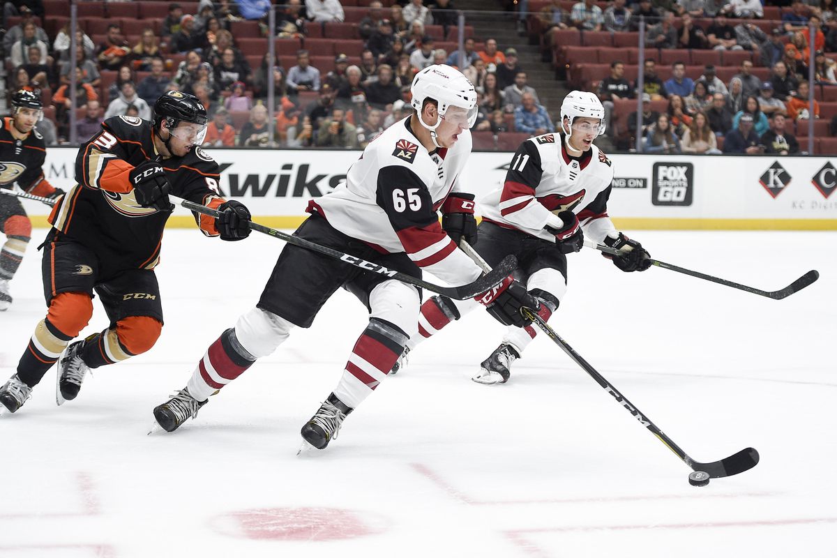 Sep 20, 2017; Anaheim, CA, USA; Phoenix Coyotes defenseman Kyle Wood (65) moves the puck under pressure by Anaheim Ducks center Kalle Kossila (83) during the first period at Honda Center.